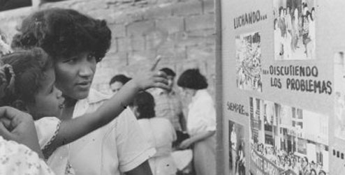 A woman and child look at a public information notice